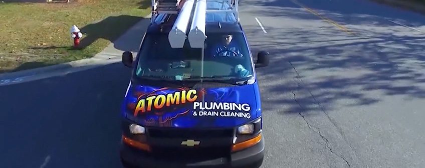 Atomic Plumbing service truck parked on a Hampton Roads street