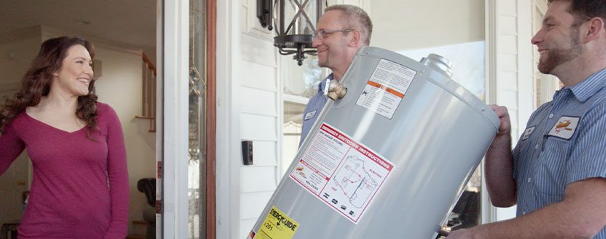 Plumber installing a water heater